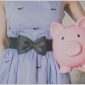 girl in blue dress holding piggy bank