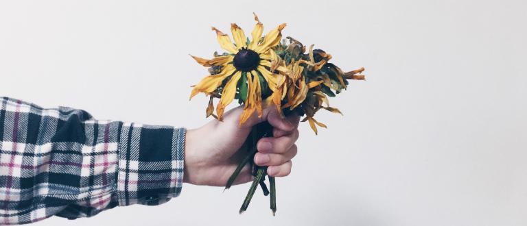 outstretched arm holding bought of flowers