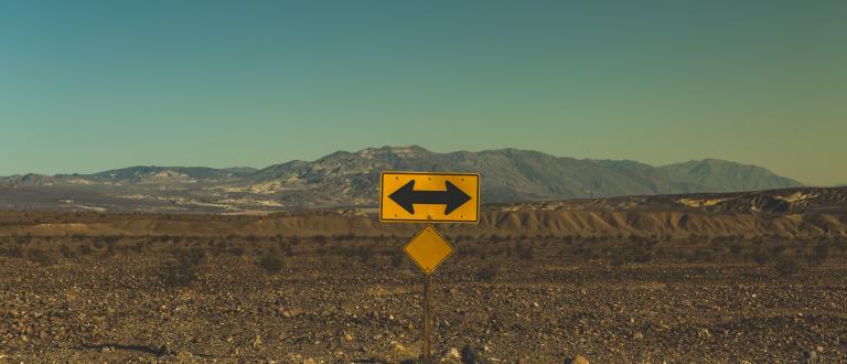 Image: yellow sign with mountains in background