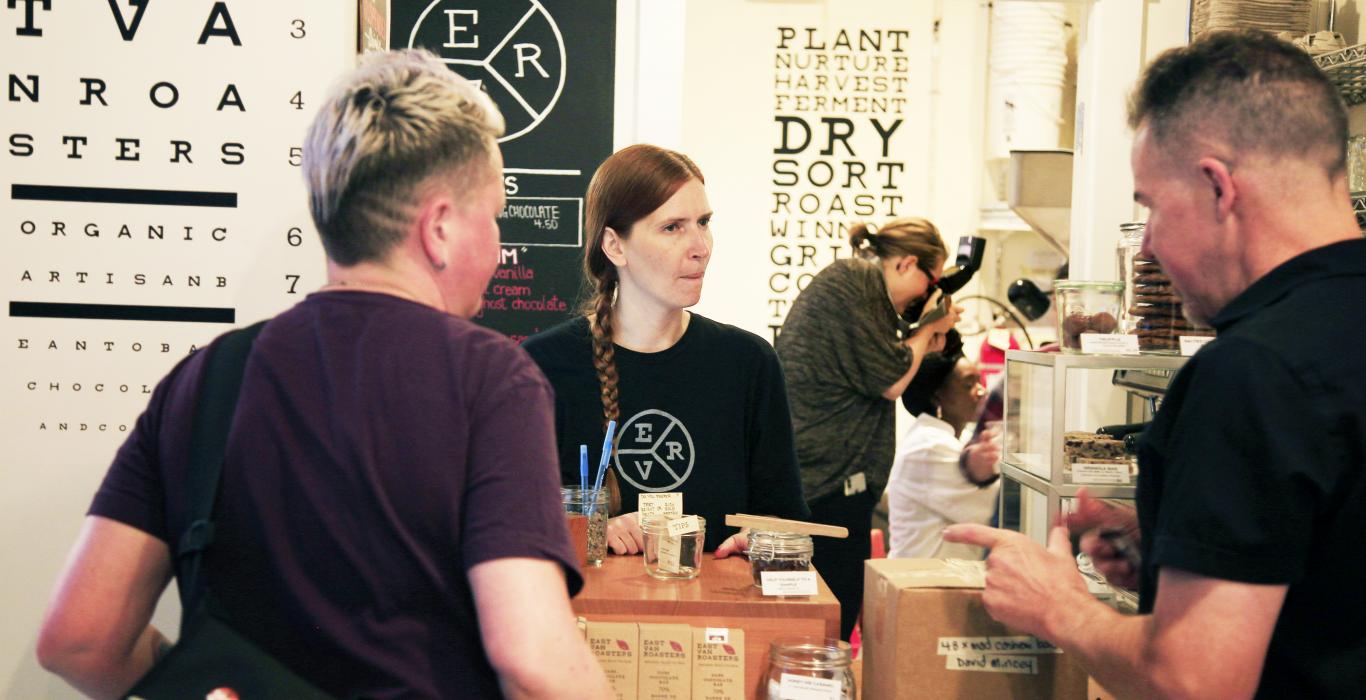 social enterprise cafe, patrons talking to barista