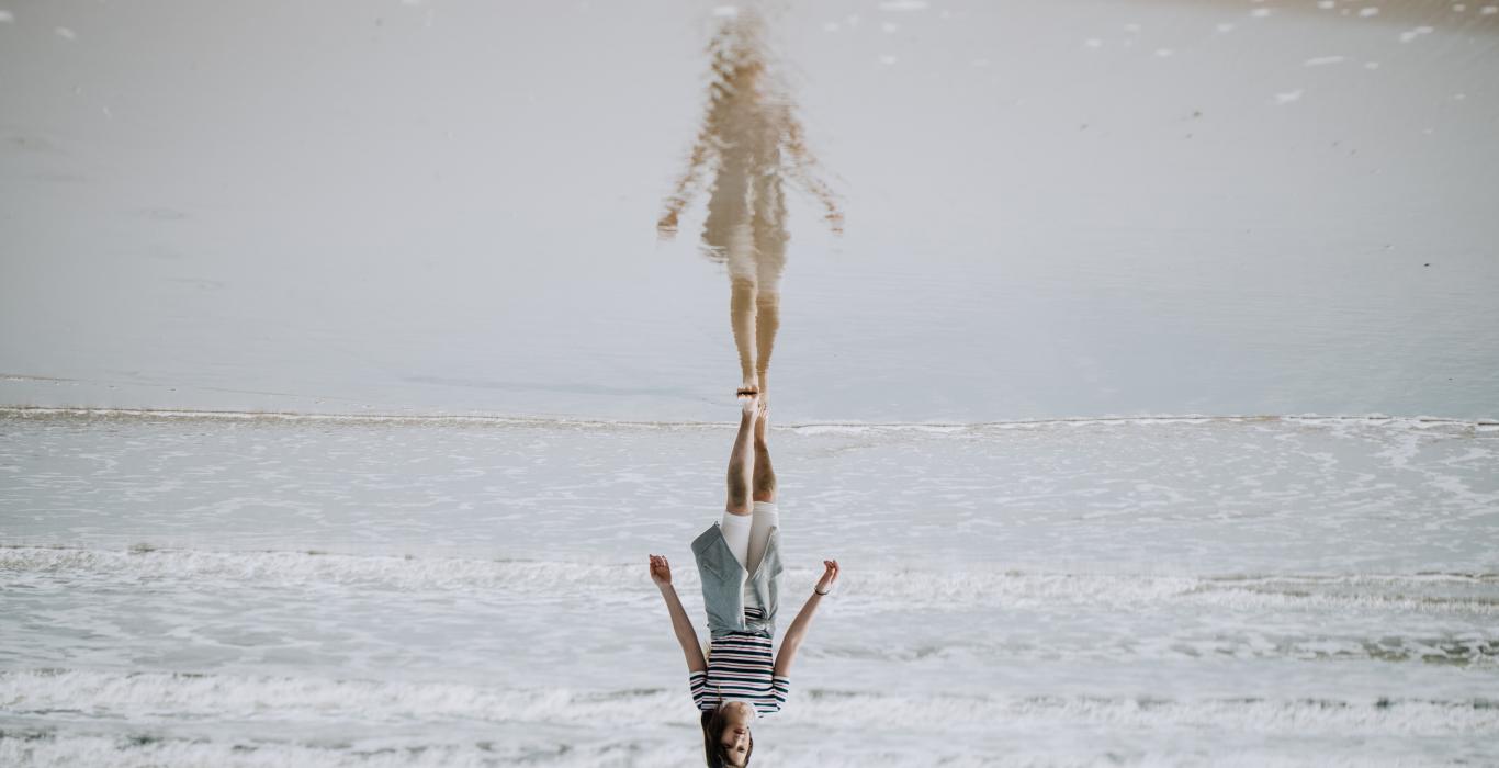 Woman walking on water and her reflection