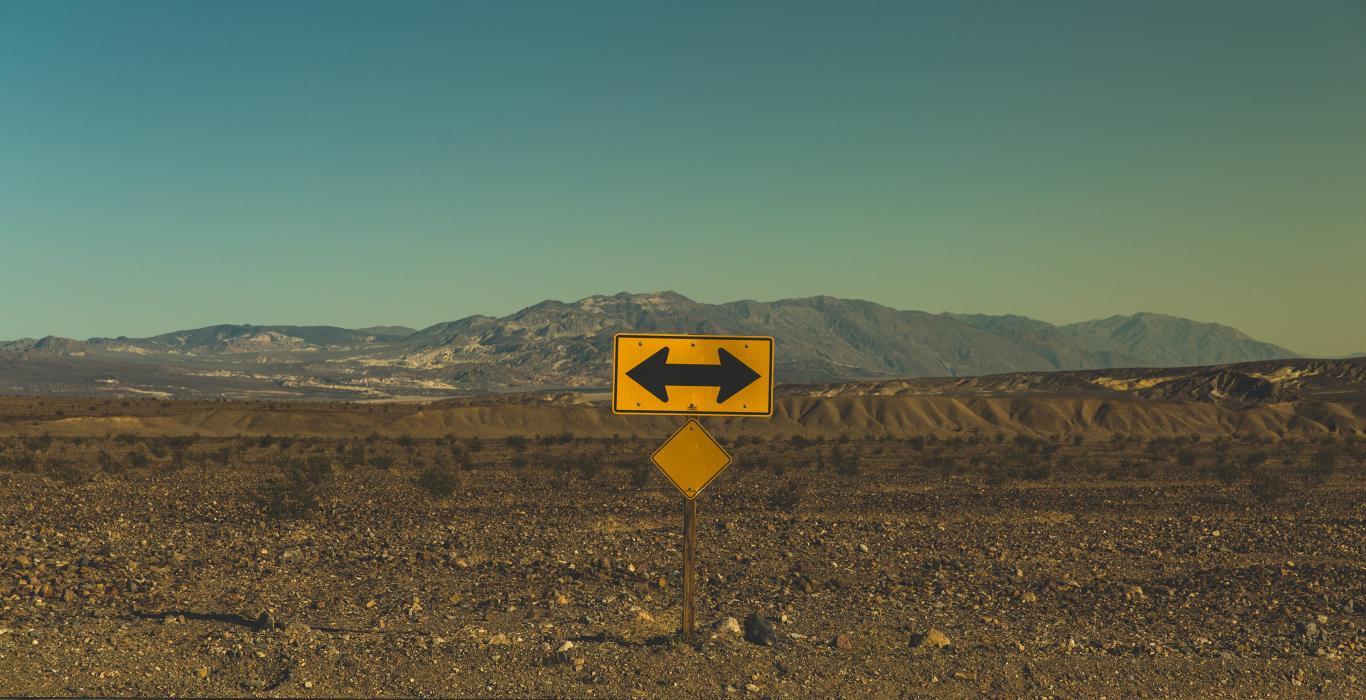Image: yellow sign with mountains in background