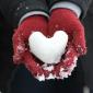 Heart shaped snowball in gloves