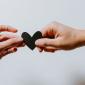 two hands holding paper heart